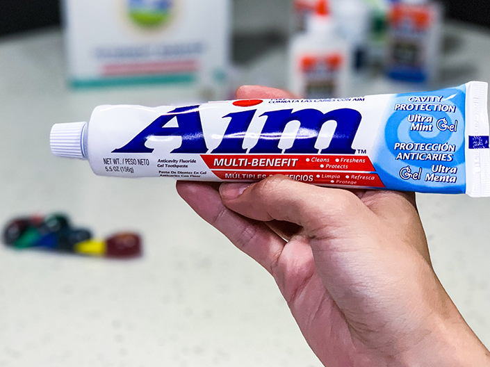 hand holding tube of toothpaste